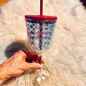 Plastic girly wine glass with straw.